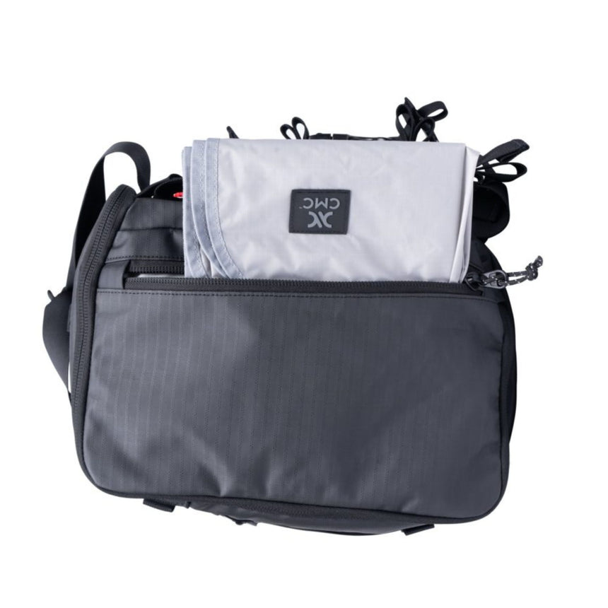 CMC Lotus Tech Back Pack showing unzipped side pocket with mat accessory popping out of it