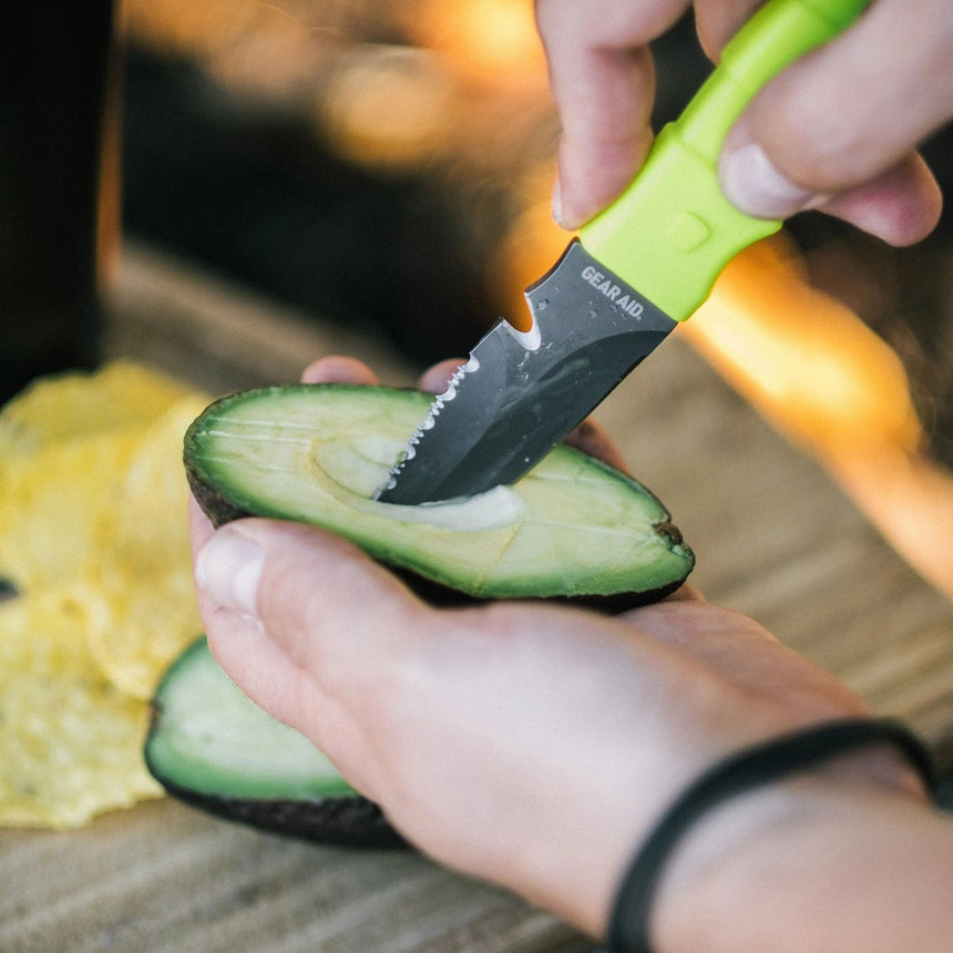 Hand model demonstrating Green Gear Aid Akua River Knife Slicing an Avacodo
