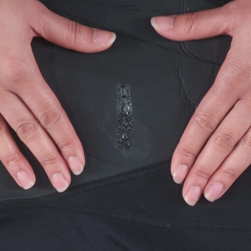 Dried repair of back neoprene demonstrating GearAid Black Witch Aquasure Neoprene Adhesive