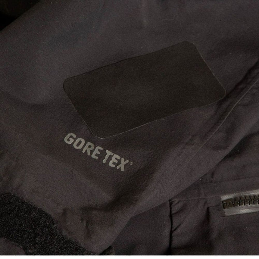 Black Rectangle Gear Aid Tenacious Tape GORE-TEX Fabric Patches used to repair a Tear in a Black GoreTex Jacket