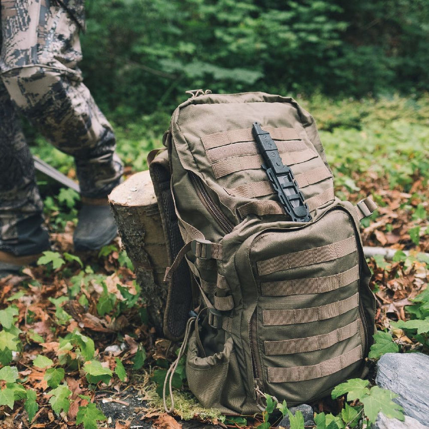 Black Gear Aid Kotu Knife mounted on the front of a coyote coloured gear bag