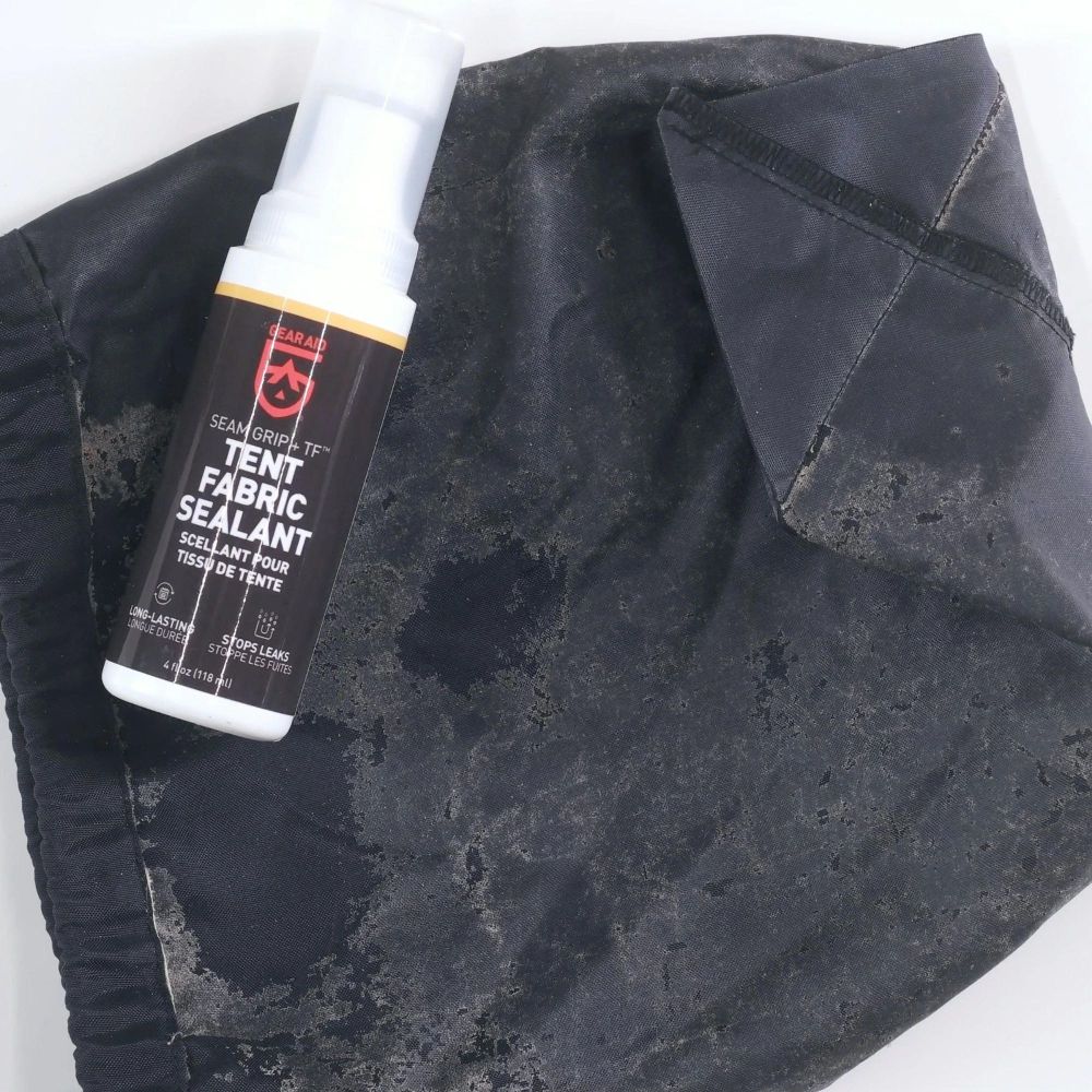 Gear Aid Seam Grip Tent Fabric Sealant resting on top of pouch needing waterproofing