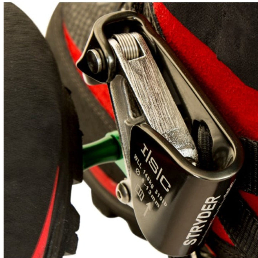 Close-up view of the ISC Stryder Right Foot Ascender secured on a red climbing boot, highlighting its stainless steel cam and durable construction for reliable rope ascents