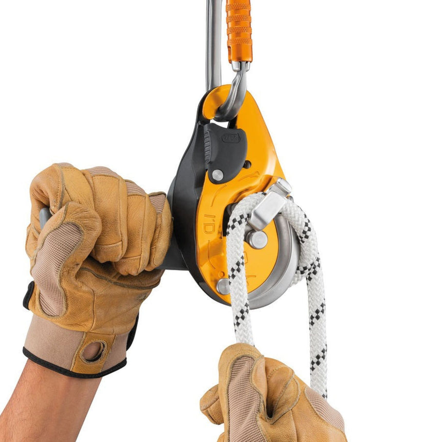 Petzl ID EVAC Descender in use showing the ergonomic handle which allows unlocking the rope and comfortably controlling the descent.