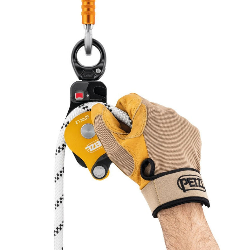 Professional wearing a glove showing the rope can be installed with the Petzl Spin L2 Double Pulley connected to the anchor.