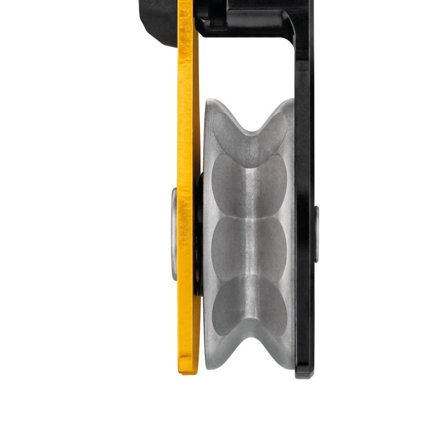 Close up of the Petzl L1D single pulley with one-way rotation and swivel showing the faceted sheave which only rotates in one direction, providing excellent efficiency when hauling and adding friction zones for the rope for additional braking when lowering.