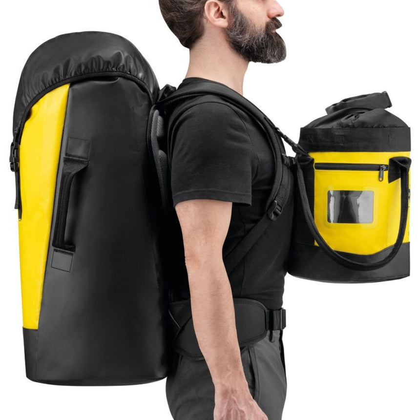 Professional wearing Petzl Transport 60 and Bucket Rope bags. Loops on the shoulder straps of the Petzl Transport 60 can be used to attach a BUCKET rope bag to carry in front.