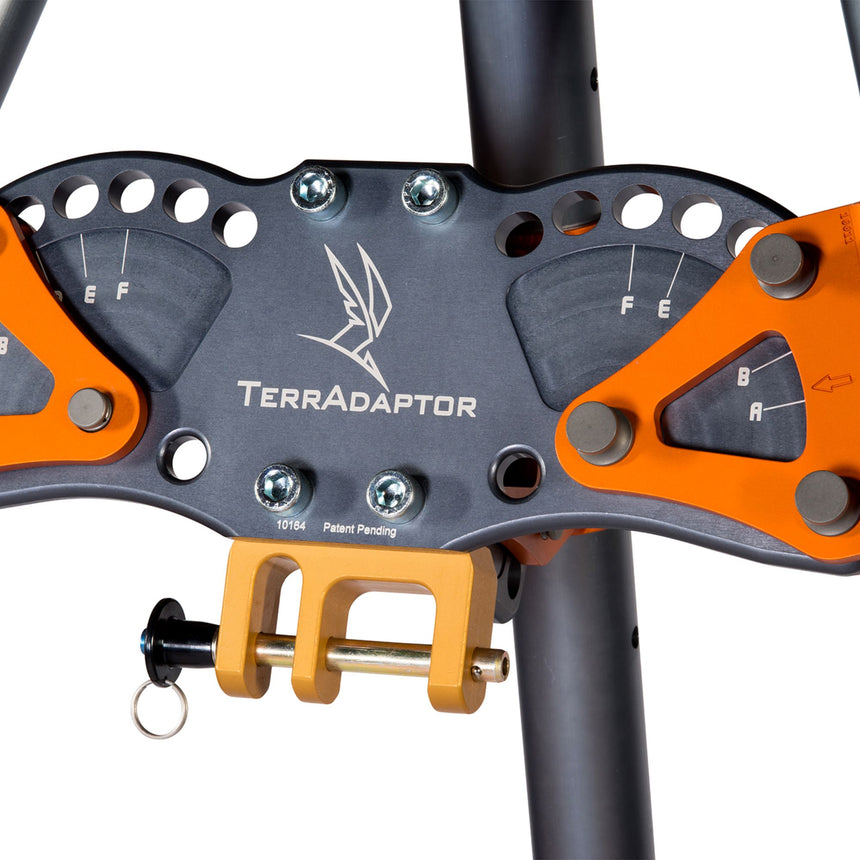 Close-up view of the SMC TerrAdaptor head unit showing multiple adjustment points, bolts, and attachment slots for precision setup on uneven terrain.