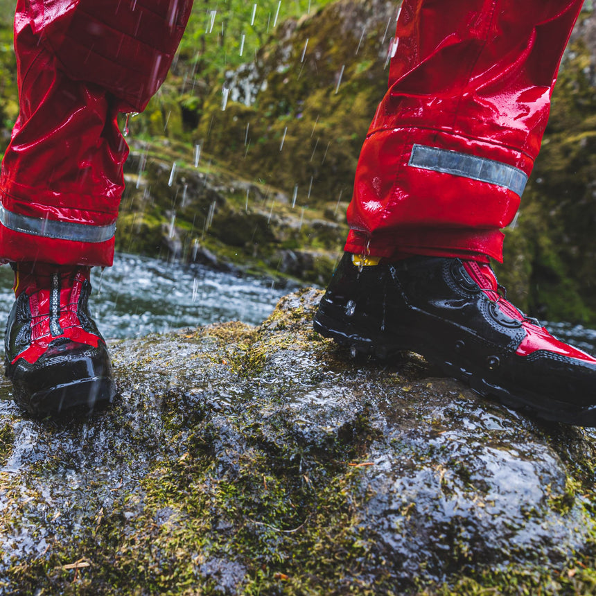 Person showing waterproof WRS Rescue Boots in the rain under drysuit