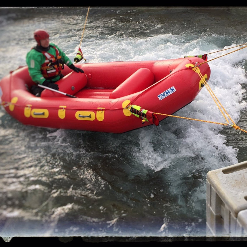 WRS rescue raft in actin with ropes attached in whitewater