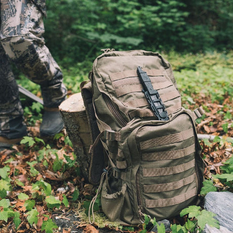Black Gear Aid Kotu Knife mounted on the front of a coyote coloured gear bag