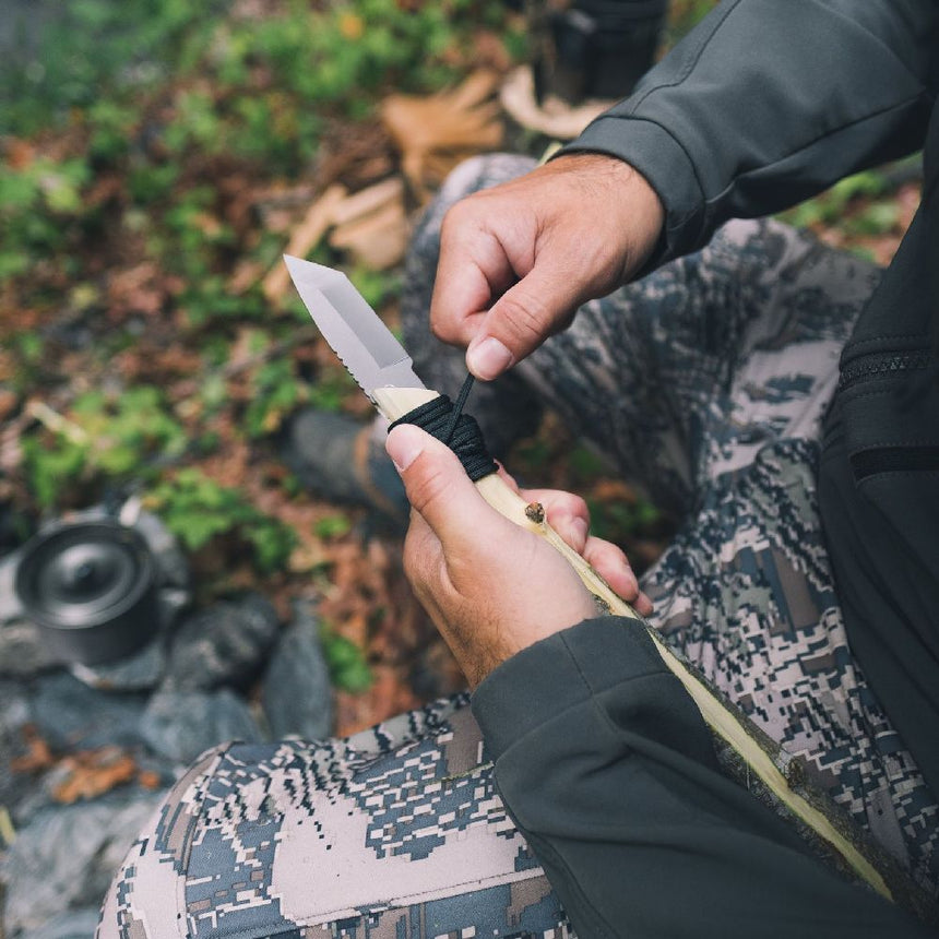 Gear Aid Kotu Knife in use outdoors and being attached to a stick 