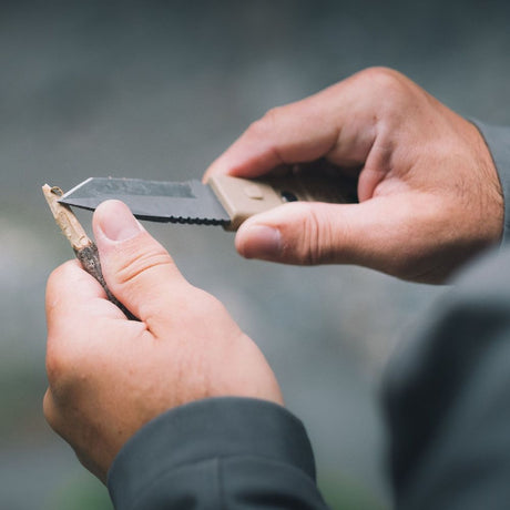Coyote Gear Aid Kotu Knife being used to pair a twig 