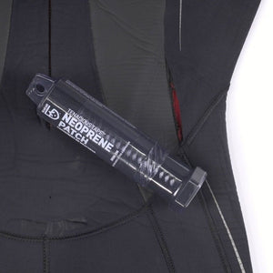 Gear Aid Tenacious Tape Neoprene Patch resting on a wetsuit with a tear in need of repair 
