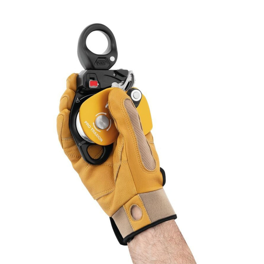 Professional wearing gloves using the triple-action opening of the moving side plate on the Petzl Pro Traxion Pulley