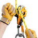 Professional wearing gloves operating the Petzl Rig descender ergonomic handle which allows unlocking the rope and comfortably controlling the descent.