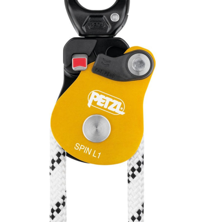 Petzl Spin L1 Pulley  on a rope showing the red mark feature which provides a visual warning when the moving side plate is unlocked.
